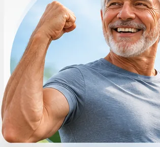 A smiling older man flexing his arm outdoors